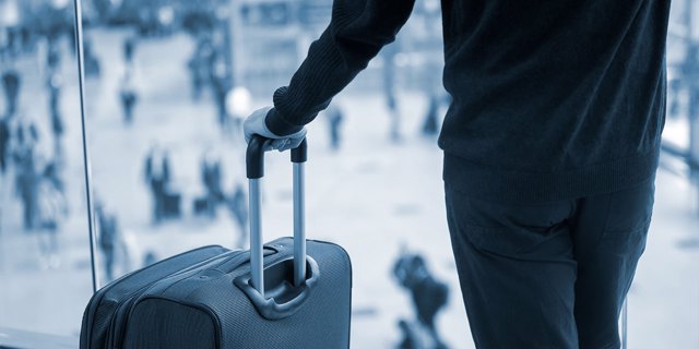 Photo of a businessman holding a suitcase
