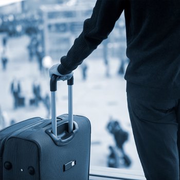 Photo of a businessman holding a suitcase