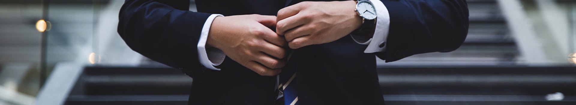 Photo of a businessman adjusting a tie