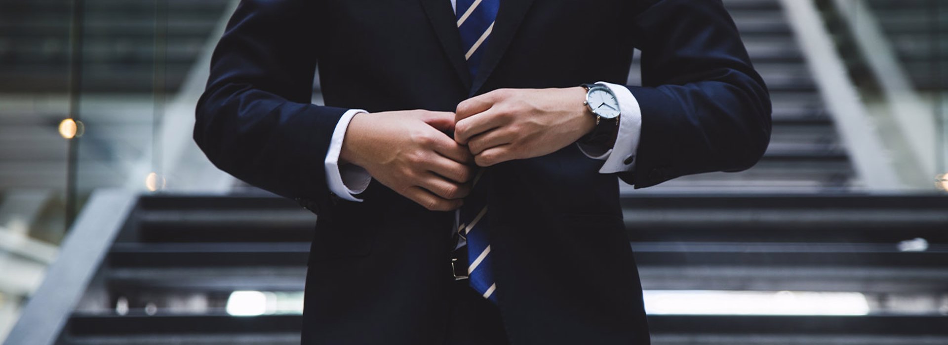 Photo of a businessman adjusting a tie